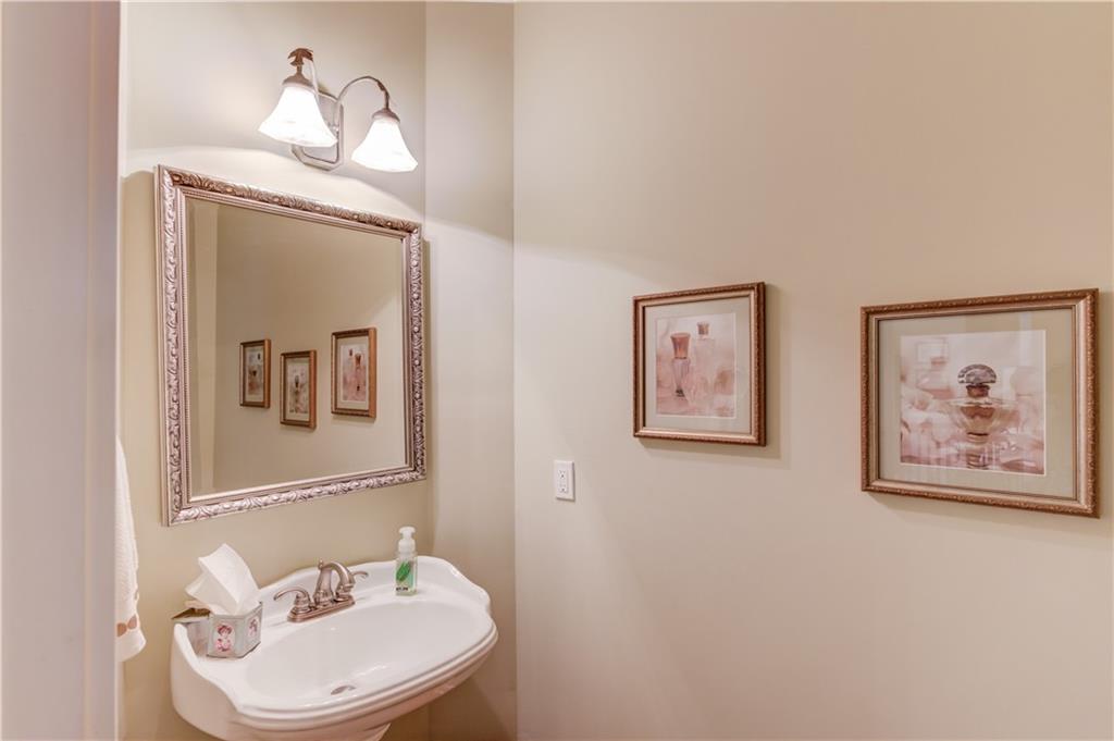 901 Providence Lane Monroe, GA 30656 - Photo 27 of 76 a bathroom with a toilet a sink and a mirror