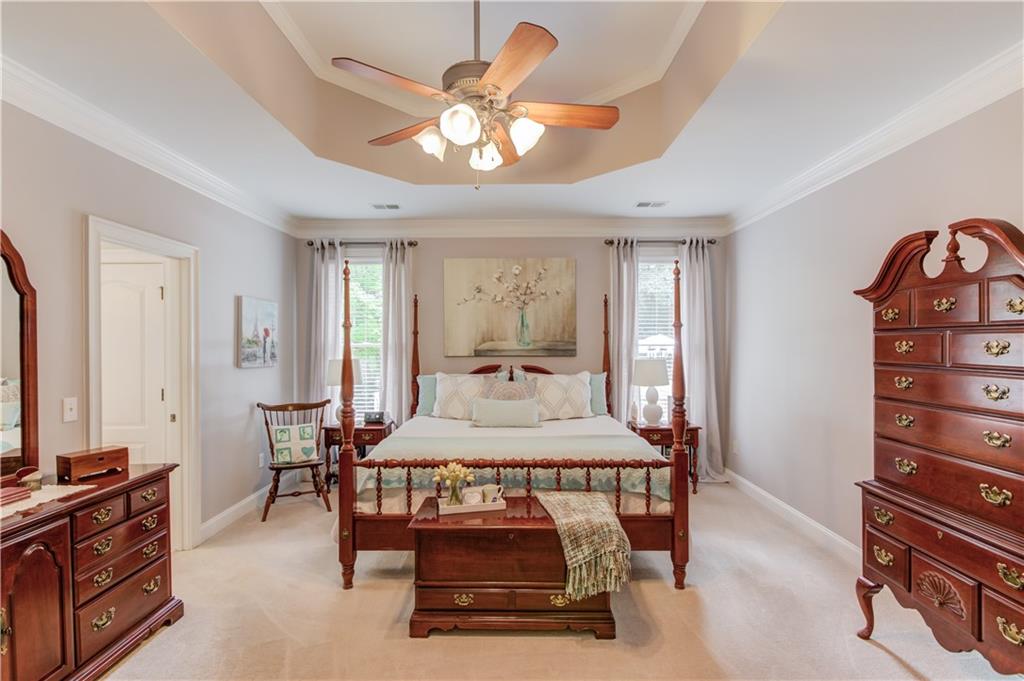 901 Providence Lane Monroe, GA 30656 - Photo 28 of 76 a bedroom with a bed and a chandelier