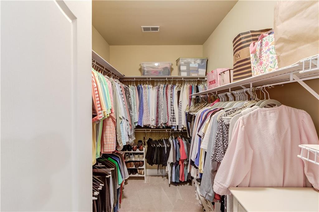 901 Providence Lane Monroe, GA 30656 - Photo 33 of 76 a view of walk in closet with clothes and shoes