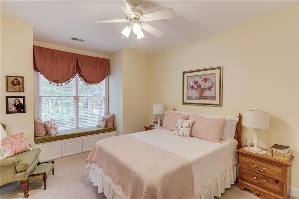 901 Providence Lane Monroe, GA 30656 - Photo 34 of 76 a bedroom with a bed a dresser next to a window