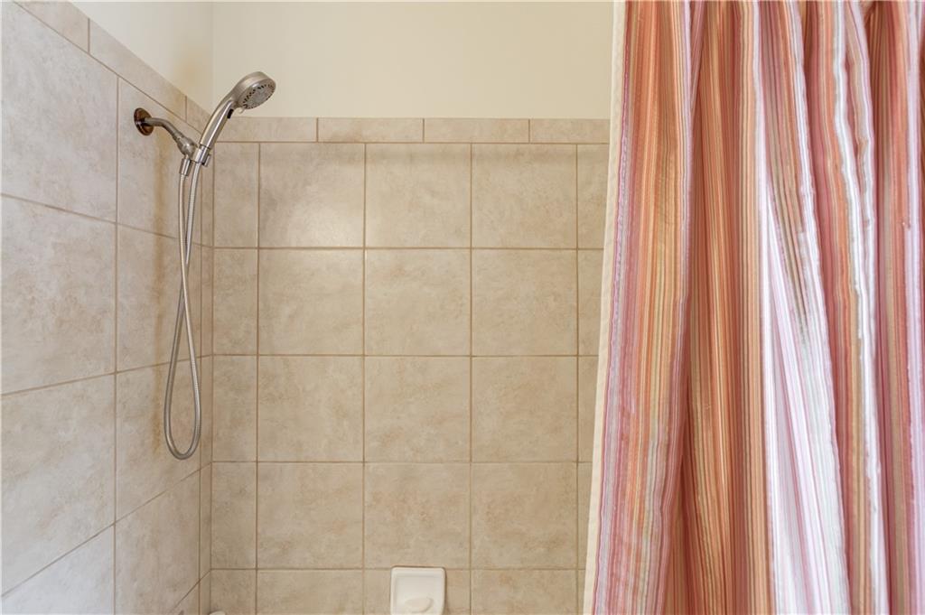 901 Providence Lane Monroe, GA 30656 - Photo 37 of 76 a bathroom with a shower and a window