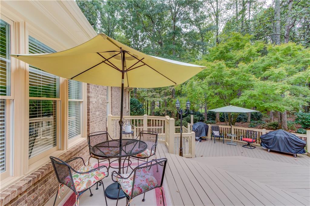901 Providence Lane Monroe, GA 30656 - Photo 52 of 76 a view of a patio with table and chairs under an umbrella