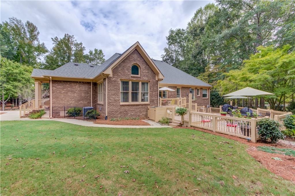 901 Providence Lane Monroe, GA 30656 - Photo 61 of 76 a front view of a house with a garden and trees