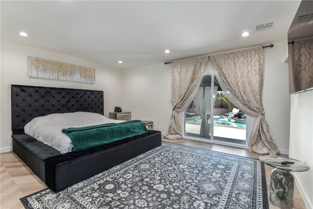 9728 Rhea Avenue Northridge, CA 91324 - Photo 23 of 36 a bedroom with a bed and a large window