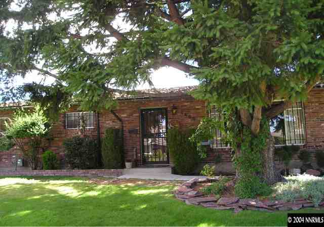 1400 Monroe Street Reno, NV 89509 - Photo 1 of 4 a view of a house with a yard garage and sitting area