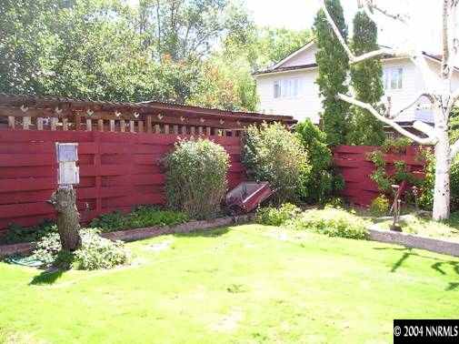 1400 Monroe Street Reno, NV 89509 - Photo 4 of 4 a view of a backyard with plants and large trees