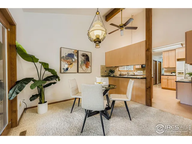 a living room with stainless steel appliances kitchen island granite countertop furniture and a rug