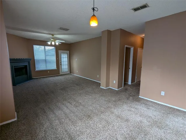 a view of an empty room with a fireplace