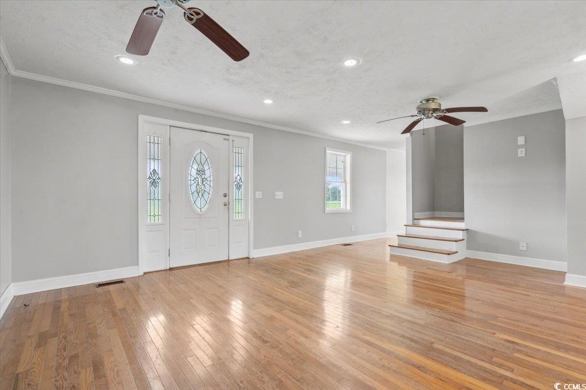 148 High Hill Road Lake View, SC 29563 - Photo 14 of 40 Entryway with ceiling fan, light wood-style floors, recessed lighting, ornamental molding, and a textured ceiling