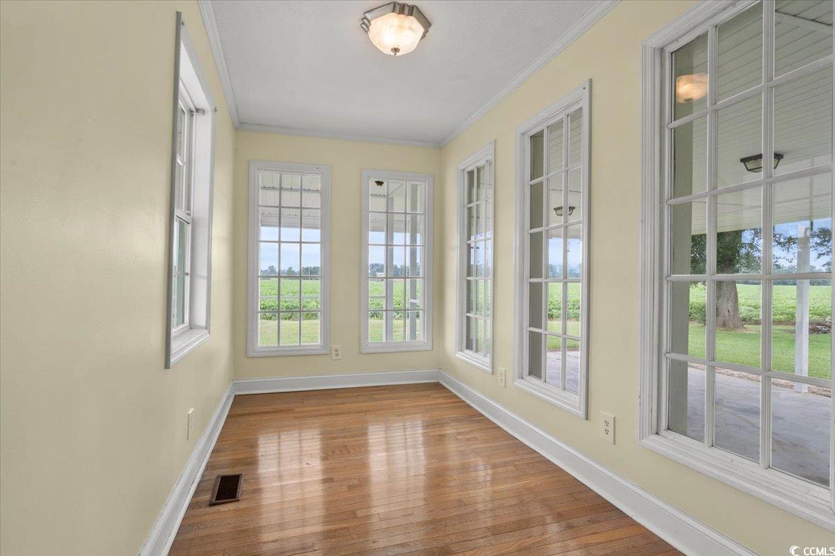 148 High Hill Road Lake View, SC 29563 - Photo 16 of 40 Unfurnished sunroom featuring ornamental molding and hardwood / wood-style flooring