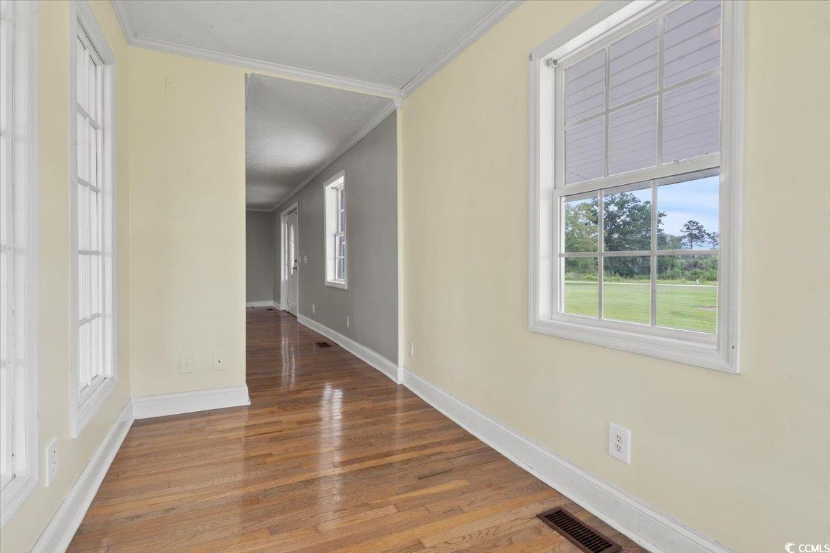 148 High Hill Road Lake View, SC 29563 - Photo 17 of 40 Unfurnished dining area featuring crown molding and wood finished floors