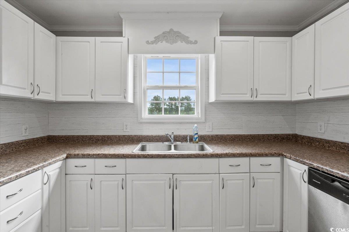 148 High Hill Road Lake View, SC 29563 - Photo 26 of 40 Kitchen with white cabinets, dishwasher, tasteful backsplash, dark countertops, and ornamental molding