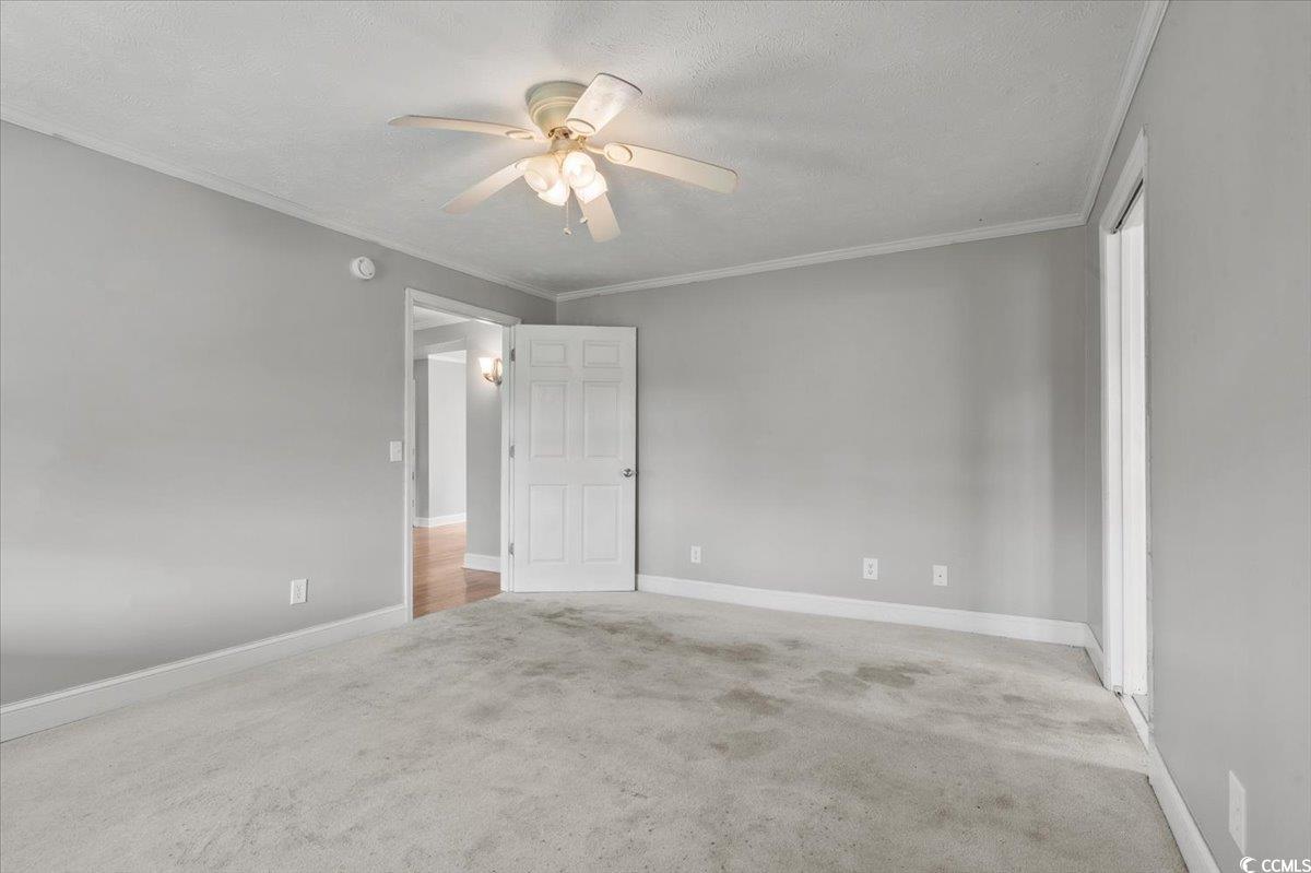 148 High Hill Road Lake View, SC 29563 - Photo 28 of 40 Unfurnished bedroom with light carpet, crown molding, a textured ceiling, and ceiling fan