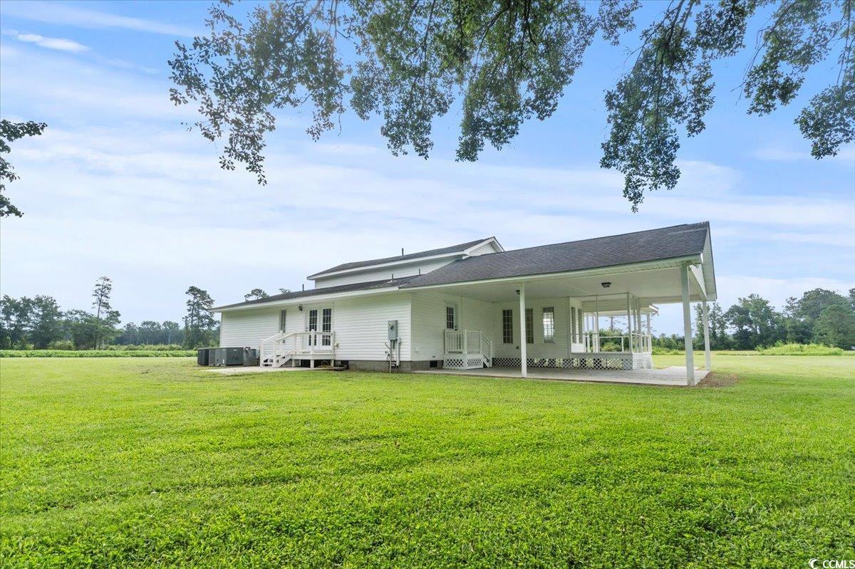 148 High Hill Road Lake View, SC 29563 - Photo 39 of 40 Back of property with a yard, a patio area, and an attached carport
