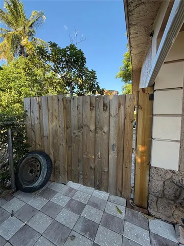 a view of a backyard with wooden fence