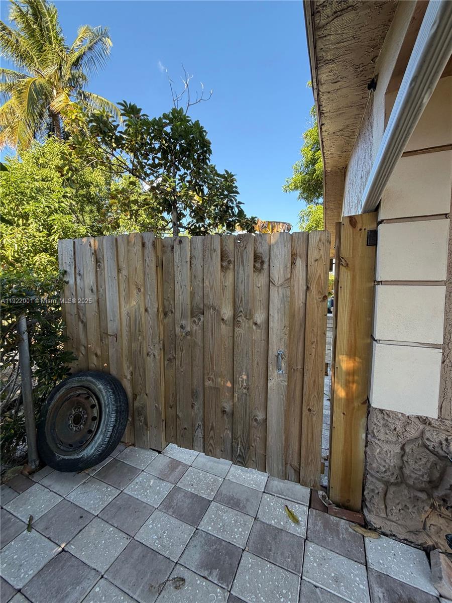 a view of a backyard with wooden fence