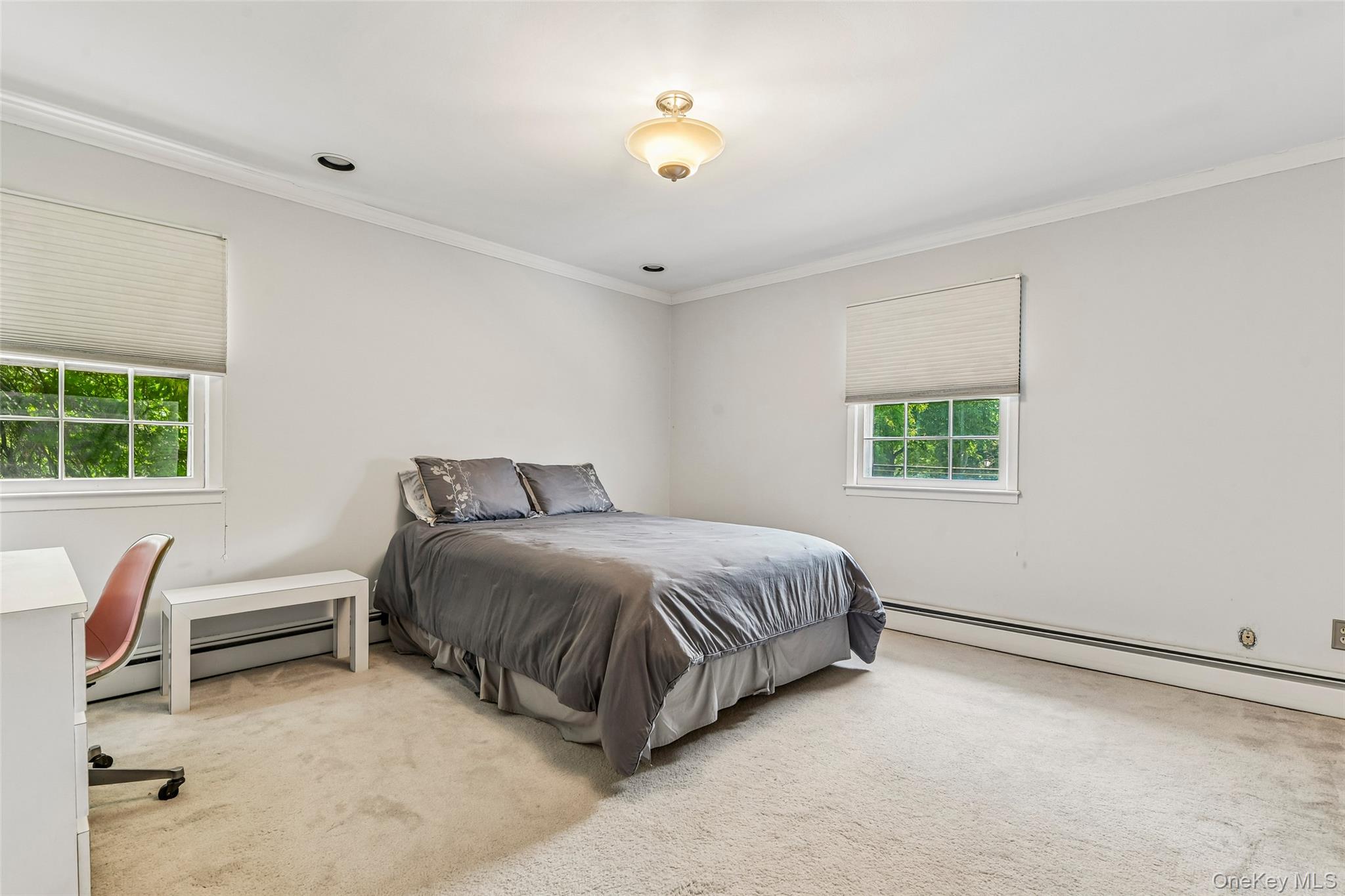 100 Hewlett Neck Road Woodmere, NY 11598 - Photo 27 of 45 a spacious bedroom with a bed and a window