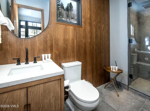 a bathroom with a sink a toilet and mirror