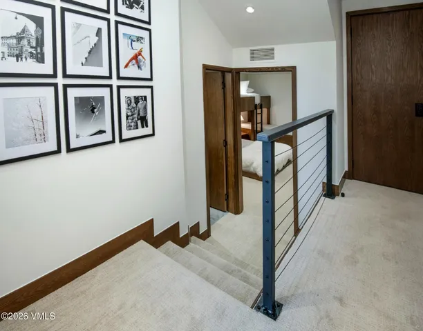 a view of a hallway with paintings on the wall