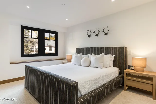 a bedroom with a large bed and a window