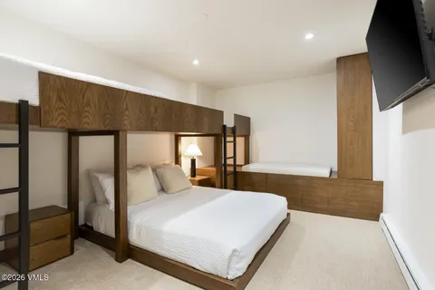 a bedroom with a bed and large window