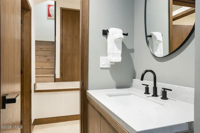 a bathroom with a sink and a mirror