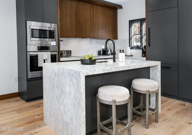 a kitchen with a table chairs sink and cabinets