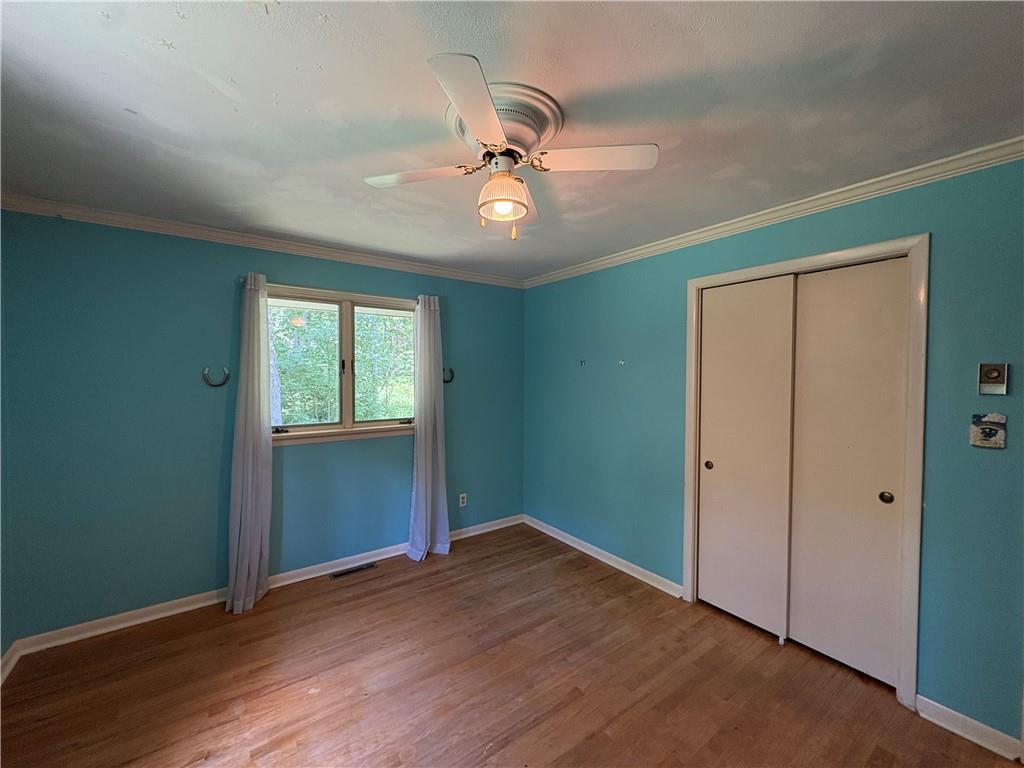 320 Cherry Hill Road Greenville, PA 16125 - Photo 23 of 38 an empty room with wooden floor ceiling fan and windows