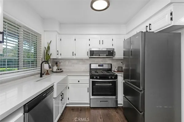 a kitchen with stainless steel appliances a stove sink and refrigerator
