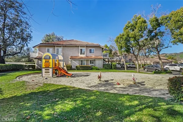 a view of a house with backyard sitting area and garden