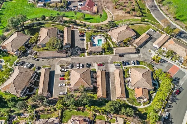 an aerial view of a house with a yard and trees