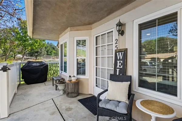 a building outdoor space with patio furniture and potted plants