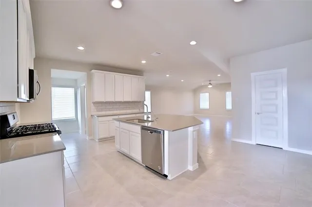 a kitchen with stainless steel appliances granite countertop a stove and a sink