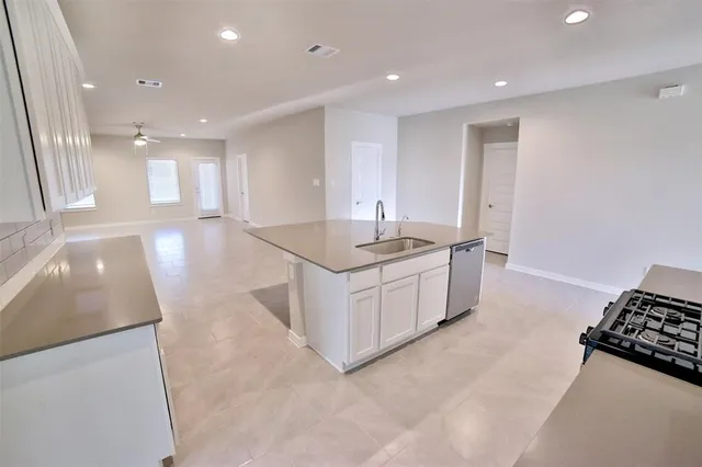 a kitchen with stainless steel appliances granite countertop a sink and a stove