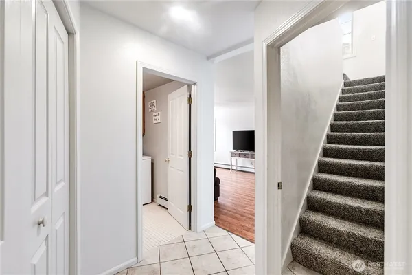 a view of a hallway with wooden floor and entryway