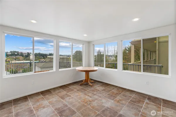 a bathroom with a large window and a bath tub