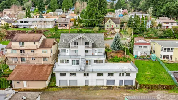 a aerial view of a house with a garden and lake view