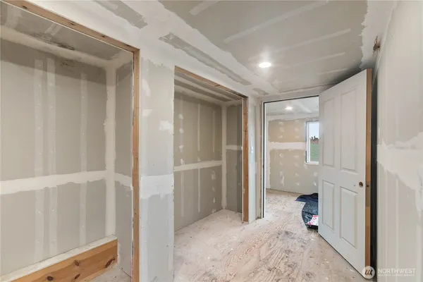 a view of a hallway with wooden shelves