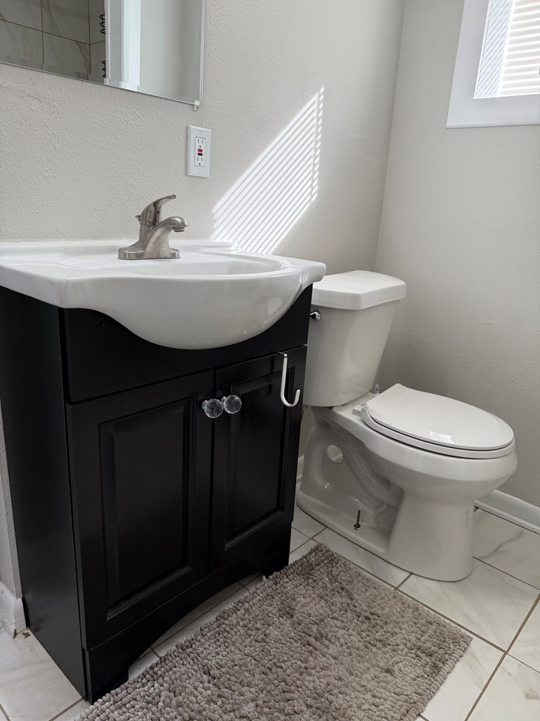 3121 Bellanca Street Columbus, GA 31909 - Photo 20 of 35 a bathroom with a sink toilet and mirror