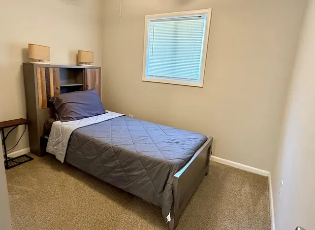 a bedroom with a bed and cabinets