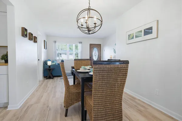 a view of a livingroom with furniture wooden floor a chandelier