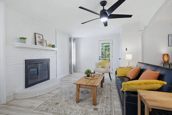 a living room with furniture and a fireplace