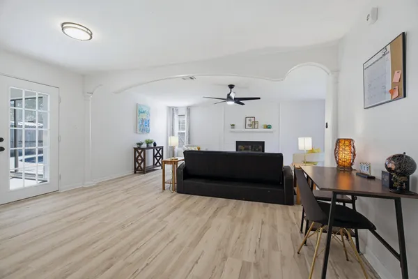a living room with furniture and wooden floor