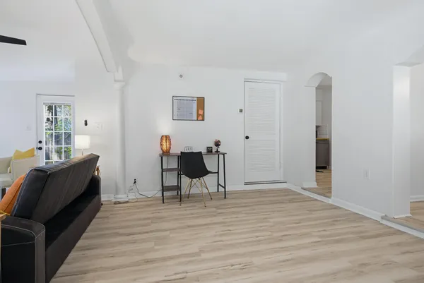 a view of a workspace with wooden floor