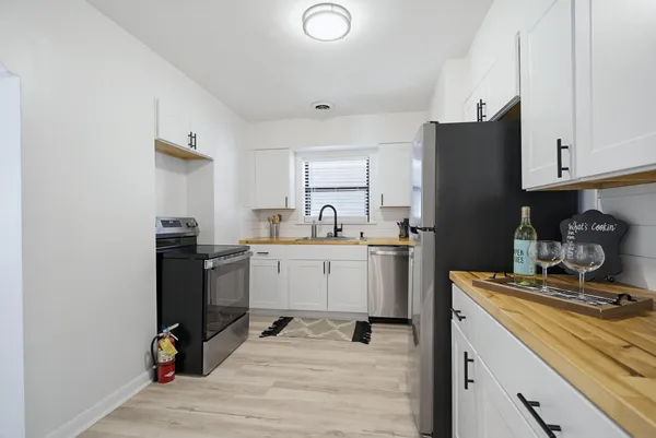 a kitchen with a sink cabinets and appliances