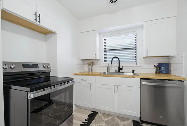 a kitchen with a sink and cabinets