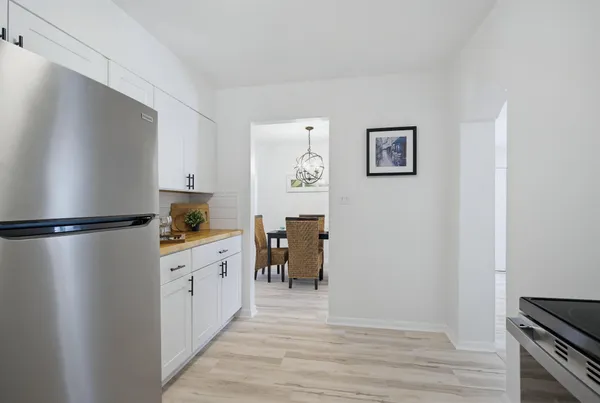 a kitchen with stainless steel appliances a refrigerator and a stove top oven