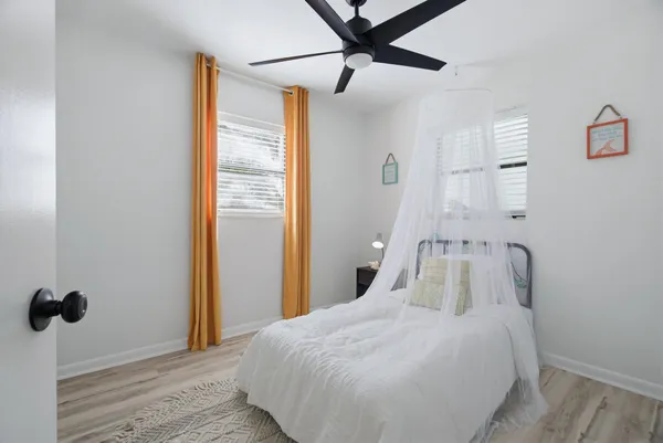 a bedroom with a bed and a chandelier