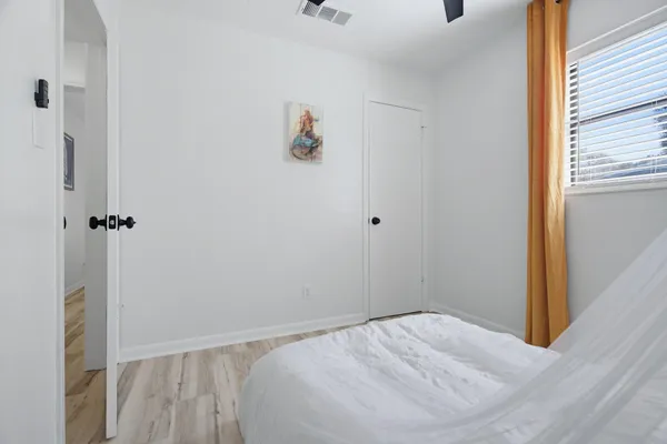 a bed sitting in a bedroom next to a window