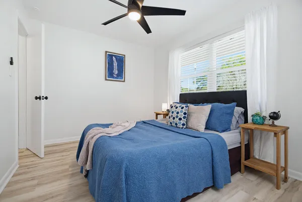 a bedroom with a bed and a chandelier